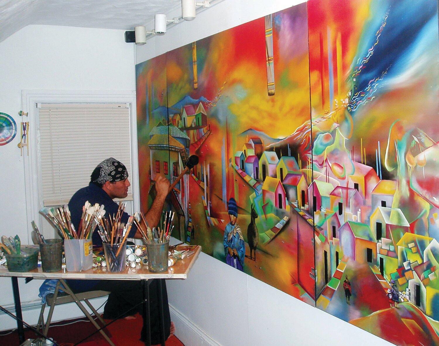 Nilton Cardenas working on a painting called "I'm From There But I'm Not There." from his series entitled Native Land.